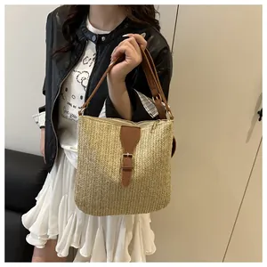 Detailed close-up of woven tote bag with V-shaped texture and brown leather strap