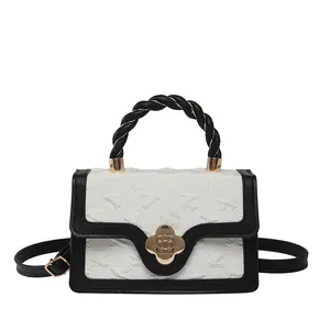 Elegant white pleated handbag with black piping and gold flower metal clasp buckle