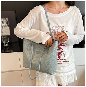 Close-up of light blue woven texture and decorative tag on a large tote bag