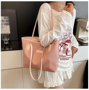 Close-up of pink woven tote bag with Fashion & Bags logo on a casual shoulder strap
