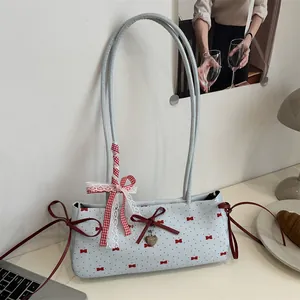 Light blue contrast color shoulder bag with red bow print and heart charm detail