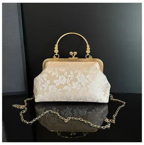 Macro detail of champagne floral embroidery on a vintage晚宴 evening bag with gold handle