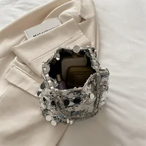 Silver large sequin bucket bag with metal chain straps showing spacious inner capacity