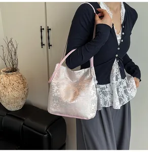 Detail of pink jacquard tote bag with traditional Chinese patterns and long tassels