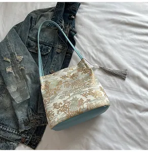 Detail of a Chinese style jacquard shoulder bag with landscape print and silk tassel