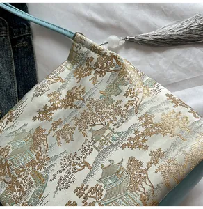 Detailed macro of bamboo leaf brocade embroidery on ivory silk Chinese style shoulder bag