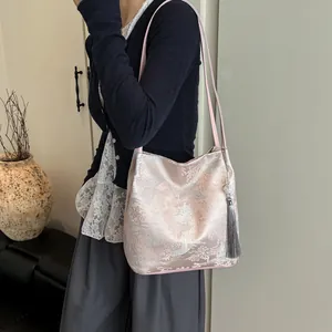 Pink silk jacquard shoulder bag with traditional Chinese landscape patterns and long tassels