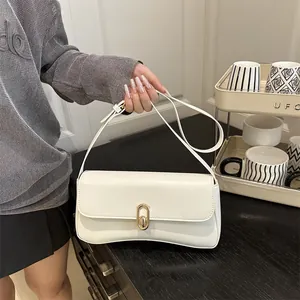Minimalist white underarm bag for women with gold oval lock and slim shoulder strap