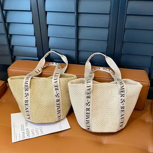 Summer woven straw tote bag with wide letter-printed canvas handles and a round base