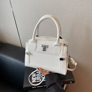 Elegant white litchi textured handbag with silver lock and top handle for women