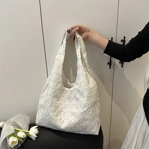 Floral embroidered tote bag with yellow flowers and paisley patterns for summer fashion
