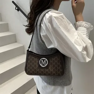 French vintage coffee brown shoulder bag with monogram print and metal M logo
