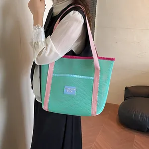 Mint green mesh tote bag with pink straps for beach travel and outdoor storage