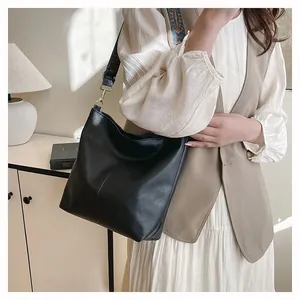Detail of black faux leather tote bag with unique ethnic style geometric wide strap