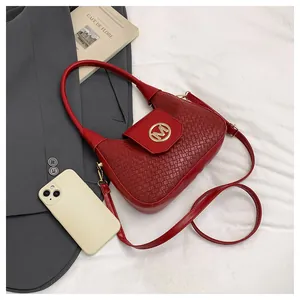 Close-up of red woven texture shoulder bag with golden M logo and half-moon design