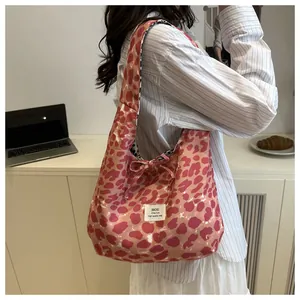 Pink leopard print tote bag with bow detail and polka dot lining shown on model