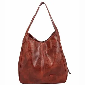 Brown leather hobo shoulder bag with stitch details and embossed logo on white background