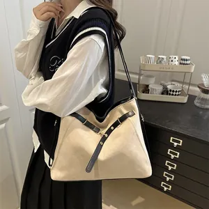 Retro contrast color tote bag with black straps and gold rivets in a cozy cafe setting