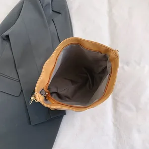 Detailed interior view of a brown tote bag with grey lining and secure zipper closure