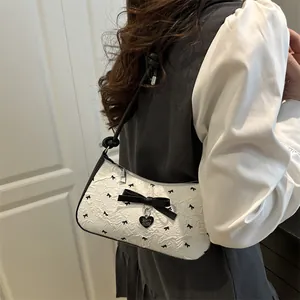 Pink bow moon underarm bag for women with white textured fabric and black knot strap