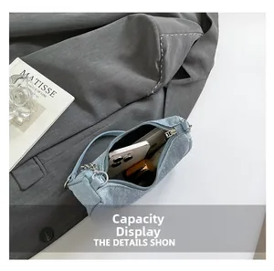 Capacity display of light blue glitter shoulder bag with smartphone and cosmetics