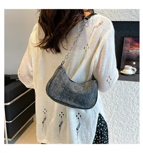 Detail shot of grey hobo bag with sparkling rhinestones and silver chain strap