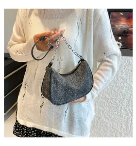 Detail of grey sparkling rhinestone hobo bag with silver chain and black strap