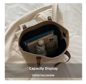 Top view of contrast color tote bag capacity showing tablet notebook and umbrella
