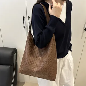 Vintage brown woven leather tote bag for women shown in a stylish minimalist interior