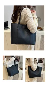 Detailed view of black tote bag showing contrast V-stitching and premium leather texture