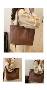 Detail view of large brown faux leather tote bag with reinforced stitching and soft texture
