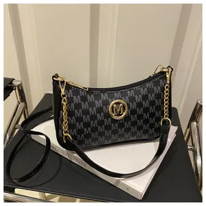 Detail of black leather and logo print crescent bag with gold logo and metal chain