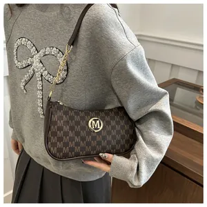 Detail of vintage coffee brown hobo bag featuring monogram jacquard and gold metal logo