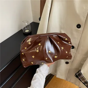 Vintage dark brown pleated cloud clutch with gold studs and high-gloss leather finish