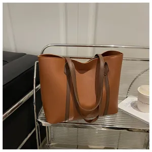 Close-up of contrast brown tote bag with large capacity and fine leather texture