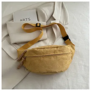 Detail of yellow corduroy waist bag with double zippers and high density strap