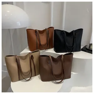 Detailed display of four tote bags in tan, black, cream, and dark brown premium leather