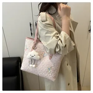 Pink tote bag detail with butterfly embroidery and cute cloud charm on shoulder strap