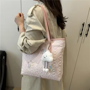 Pale pink quilted tote bag with butterfly embroidery and a plush cloud charm for women