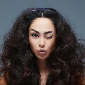 Deep brown long wavy hair extensions with voluminous texture on a clean blue background