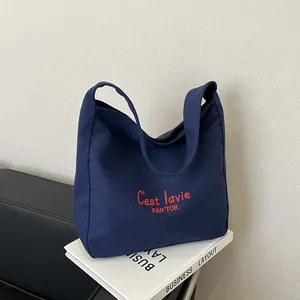 Minimalist navy blue canvas tote bag with red embroidered C'est lavie PAN'TOR lettering