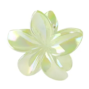 Macro detail of an 8cm aurora green plumeria hair claw clip with iridescent finish