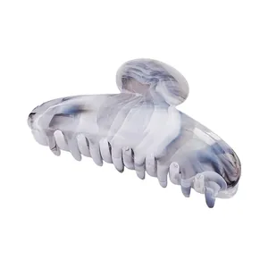 Detailed view of blue and grey marble texture hair claw clip with strong grip teeth