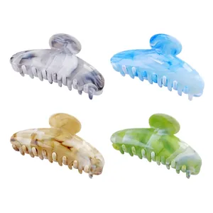 Set of four large acetate hair claw clips with marble texture patterns in vibrant colors