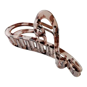 Close-up of translucent brown marble hair claw clip with a strong golden metal spring