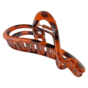 Detail view of leopard print hair claw clip showing hollow heart design and metal spring