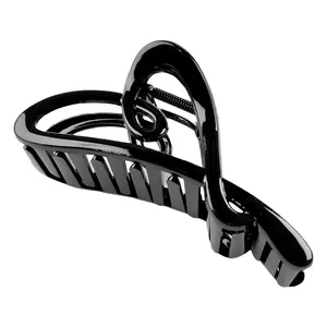 Close-up of a glossy black hair claw clip featuring an elegant hollow heart design