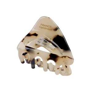 Small triangle acetate hair claw with brown tortoiseshell pattern and gold handmade logo