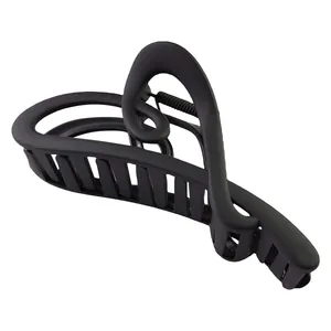 Detail view of the matte black streamlined heart-shaped hair claw clip with a refined finish