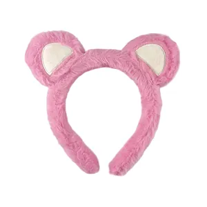 Close-up of soft pink plush fabric and fluffy bear ears on a facial headband